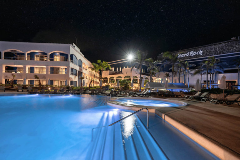 A pool and jacuzzi at night.