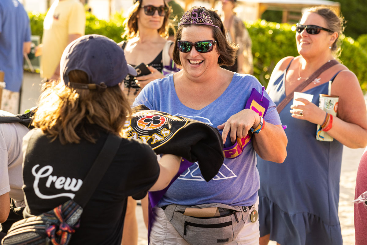 A guest receiving their loyalty club robe.