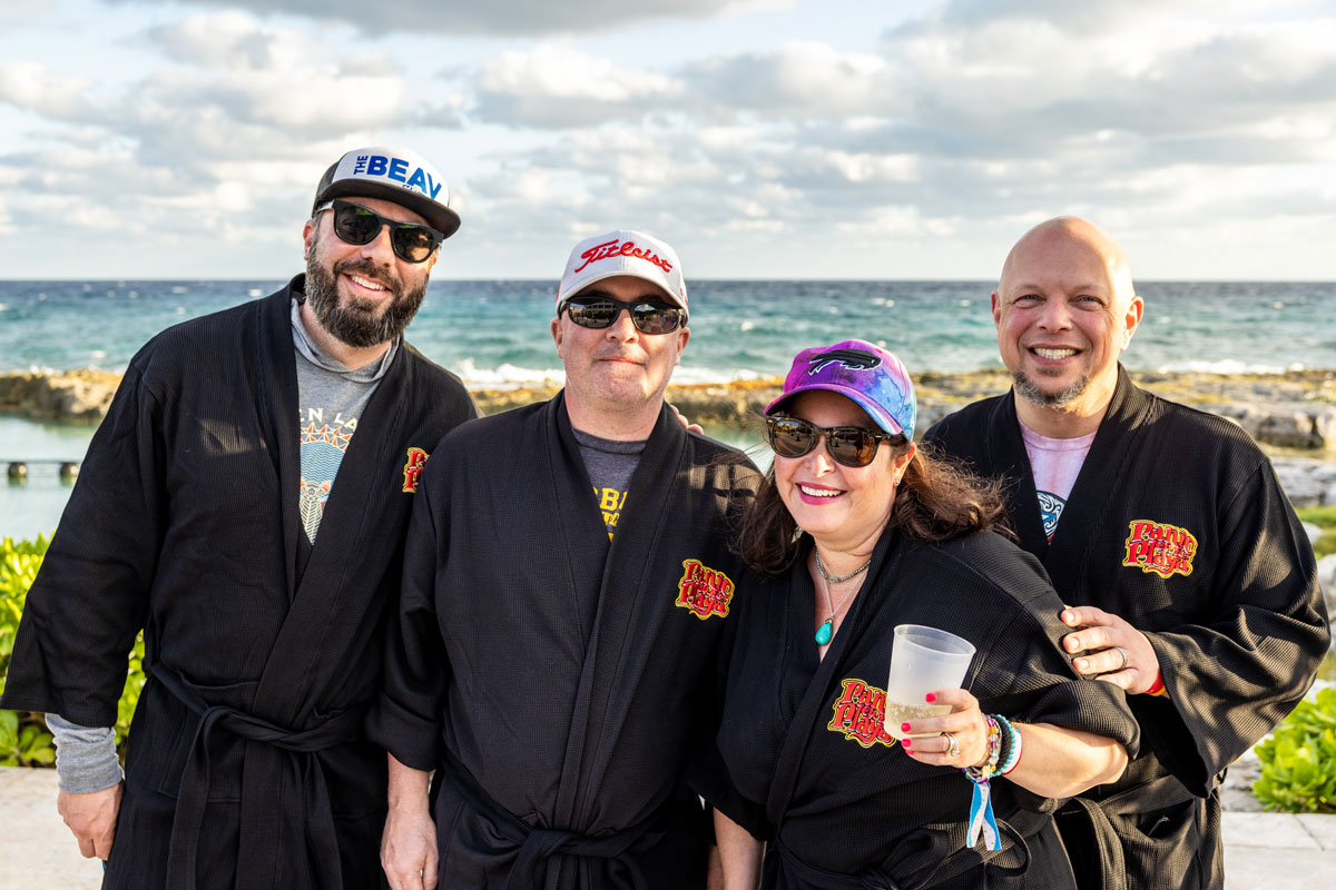 A group photo of guests in their Playas Club black loyalty robes