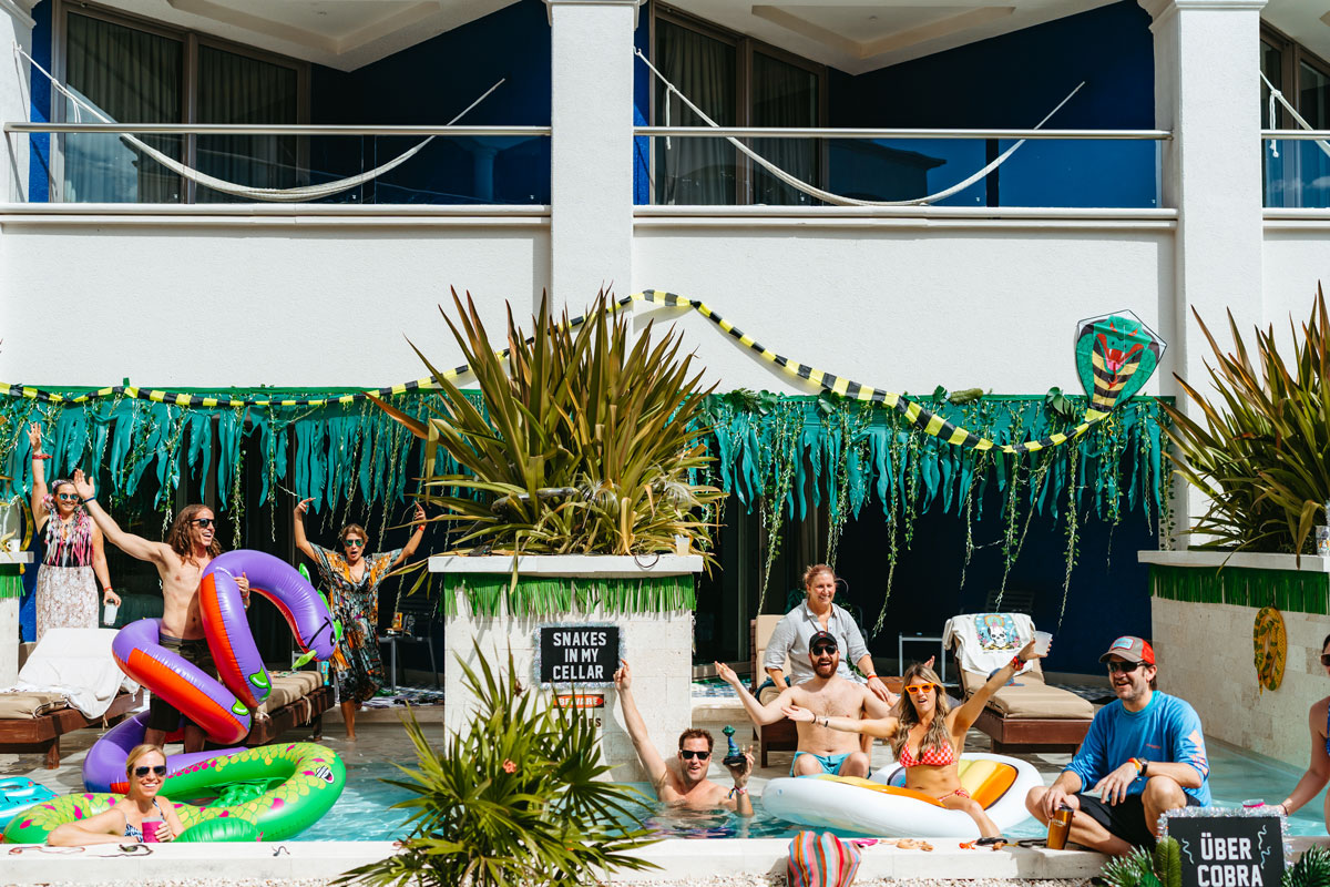 Guests posing in a swim up pool attached to their hotel room.