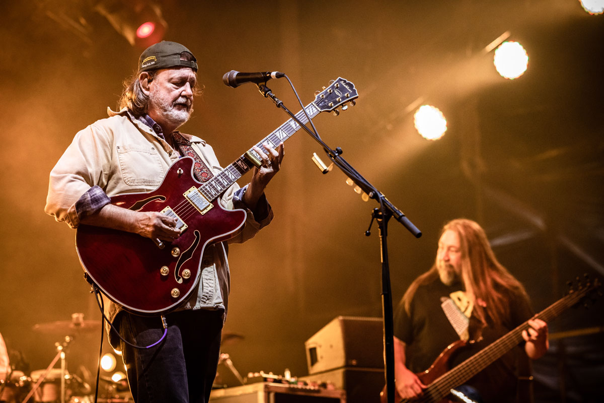 Close up photo of JB from Widespread Panic performing on the Main Stage with his hat on backwards.