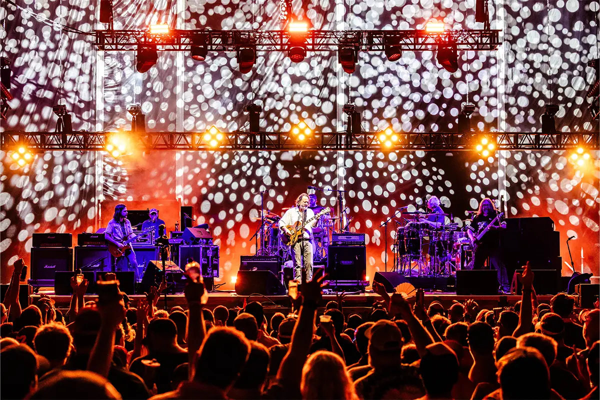Crowd Point of View photo of the Main Stage with lights shining on JB from Widespread Panic