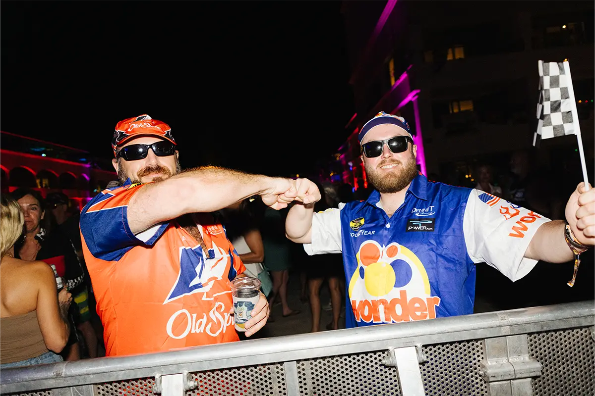 Guests fisting bumping each other in theme night costumes.