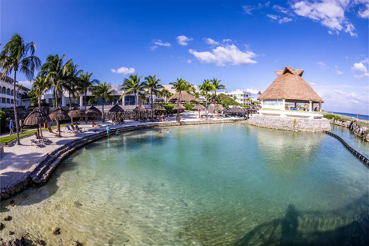 An empty lagoon with beach chairs around it in the morning
